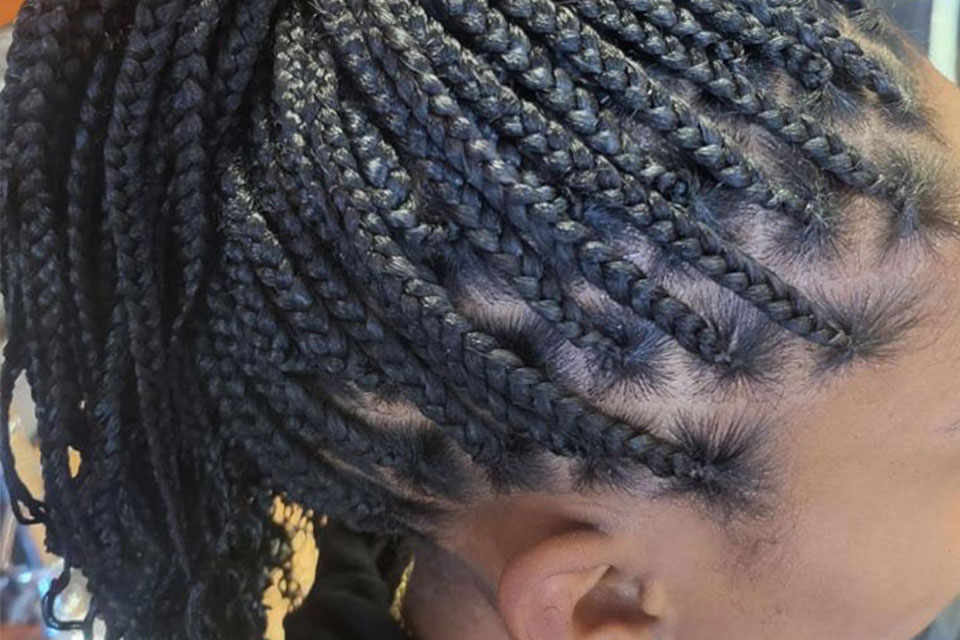 knotless braids done for customer at Virgo hair Braiding Salon. Close up image of african american woman