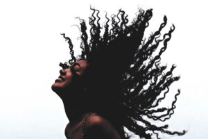 image of woman embracing her heritage with African hair braiding