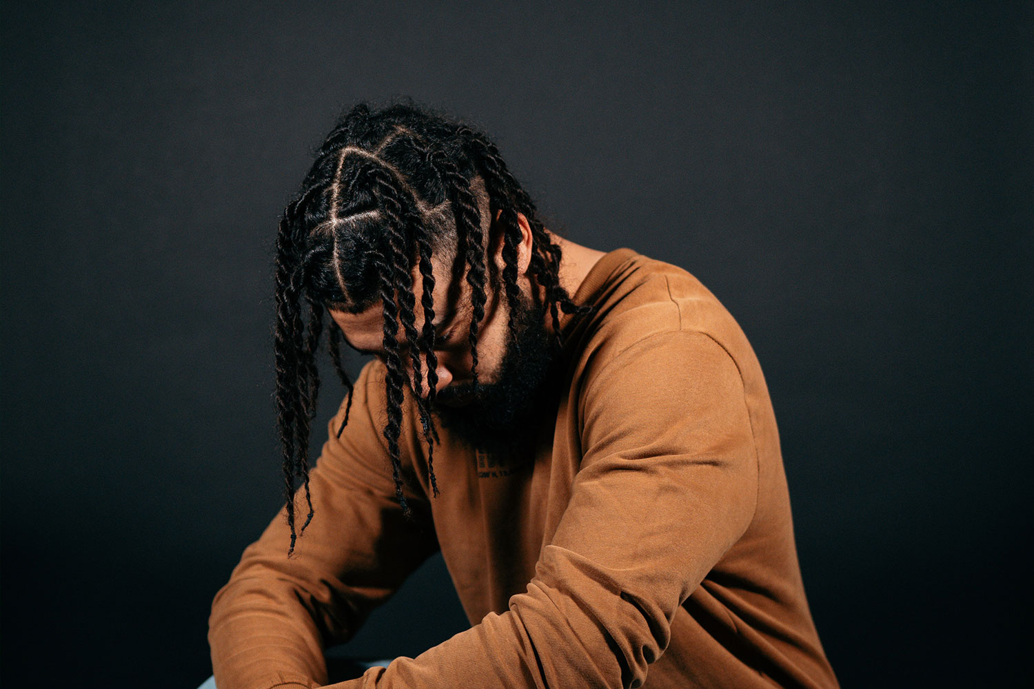 man pondering do braids help grow hair